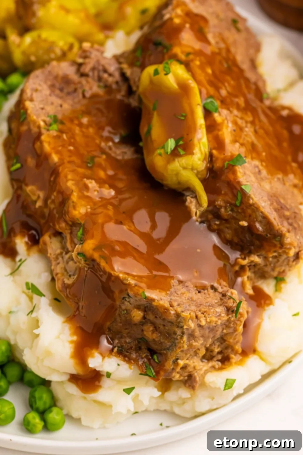 Crockpot Mississippi Meatloaf on mashed potatoes