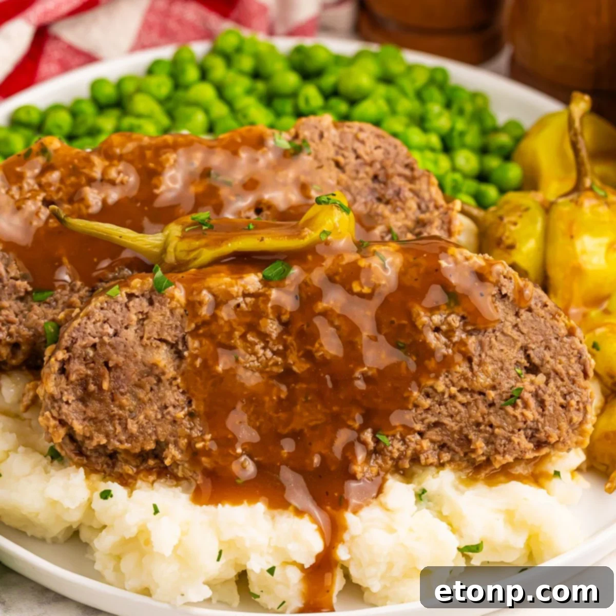 Crockpot Mississippi Meatloaf served over mashed potatoes