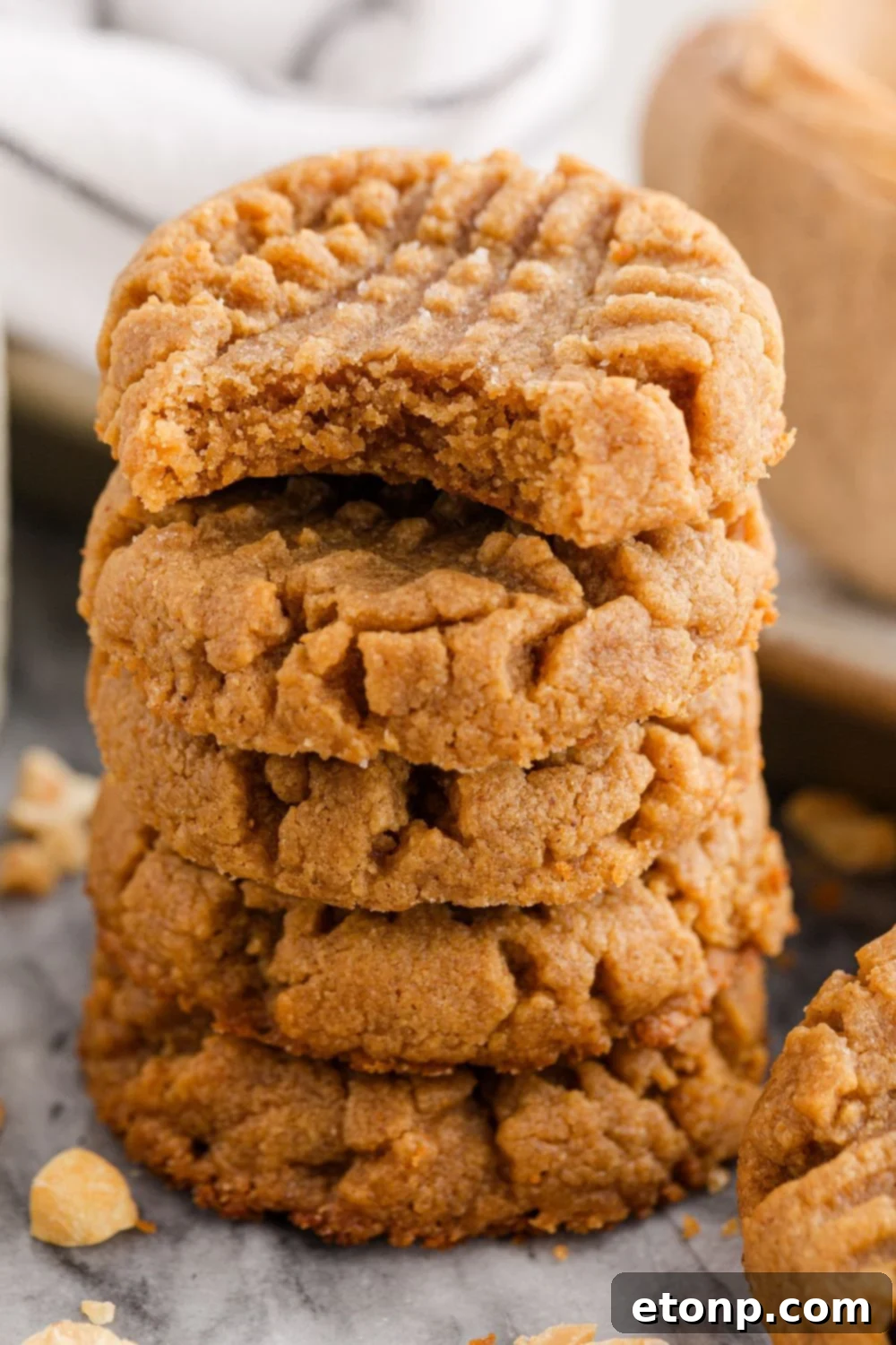 Four-Ingredient Peanut Butter Bliss: The Simplest Cookie Recipe Ever 11 Stack of peanut butter cookies with a bite taken out