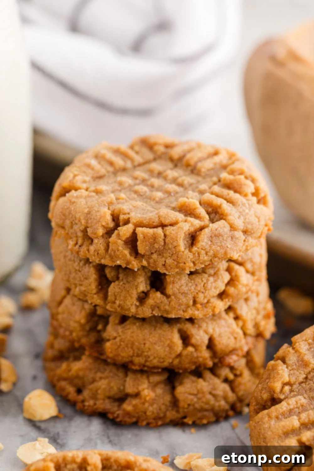 Four-Ingredient Peanut Butter Bliss: The Simplest Cookie Recipe Ever 14 Four Ingredient Peanut Butter Cookies stacked with milk