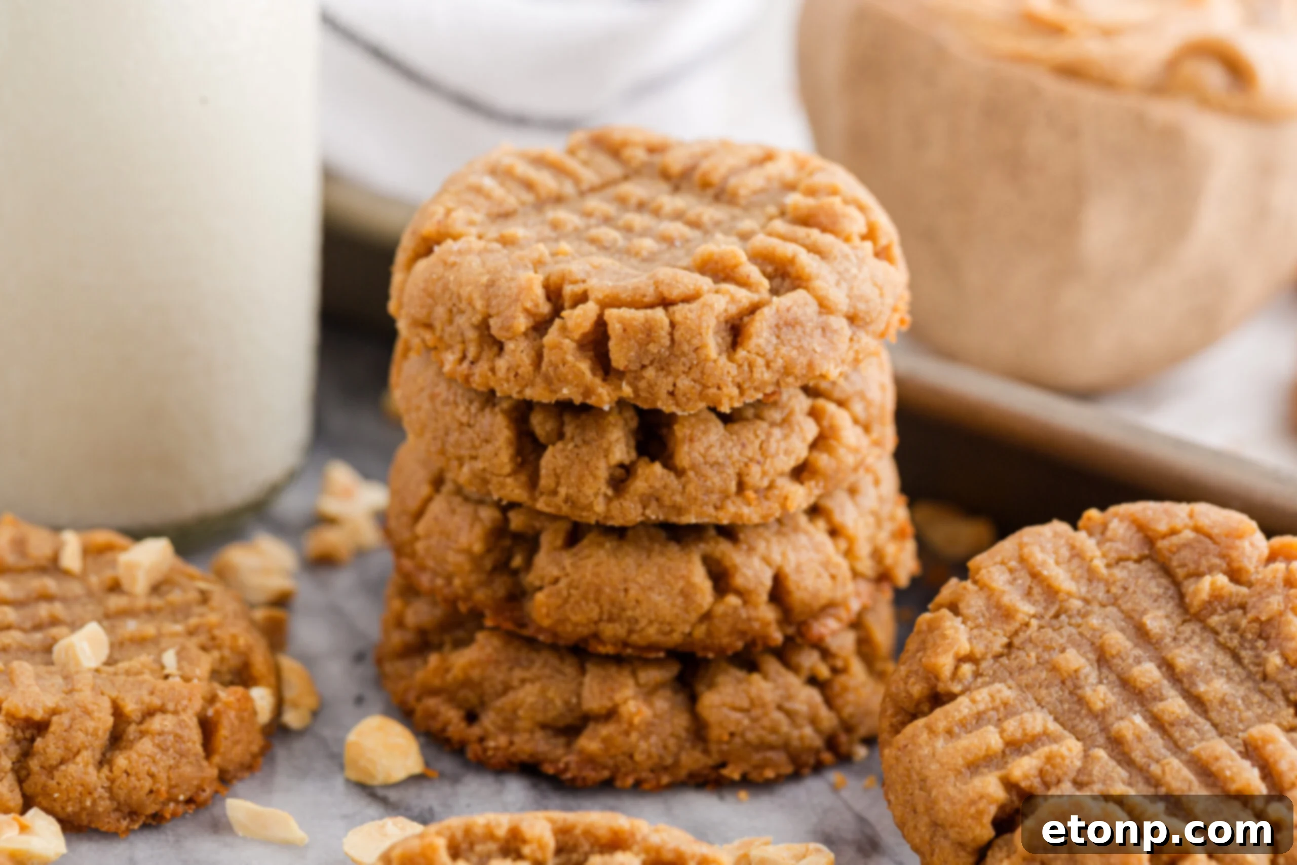 Four-Ingredient Peanut Butter Bliss: The Simplest Cookie Recipe Ever 15 Four Ingredient Peanut Butter Cookies spread with milk and tray of cookies