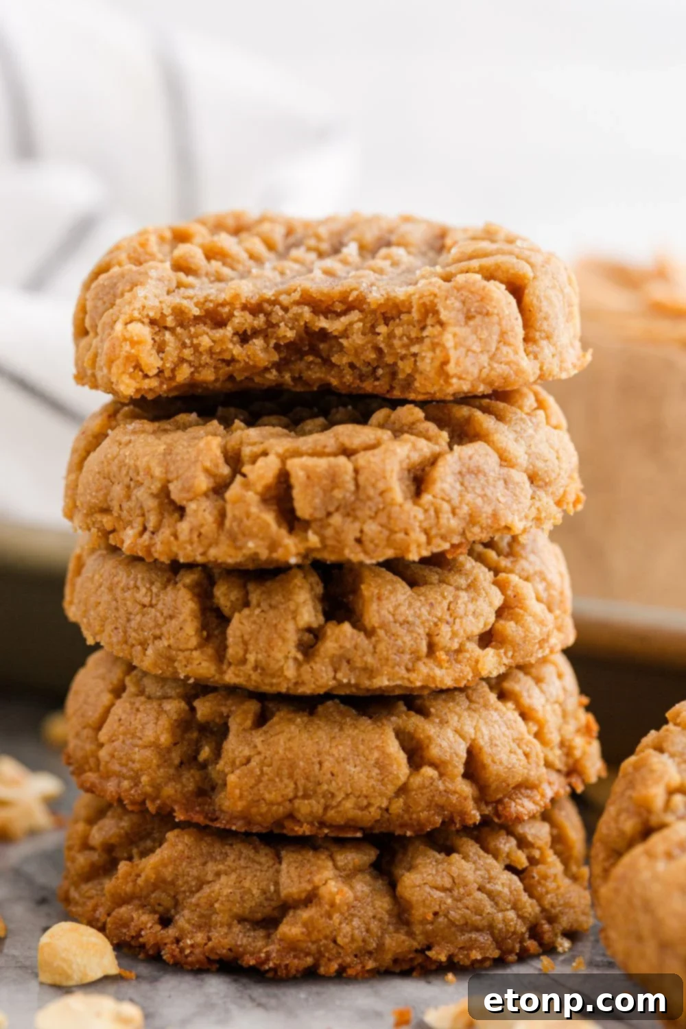 Four-Ingredient Peanut Butter Bliss: The Simplest Cookie Recipe Ever 17 Stack of peanut butter cookies with a bite