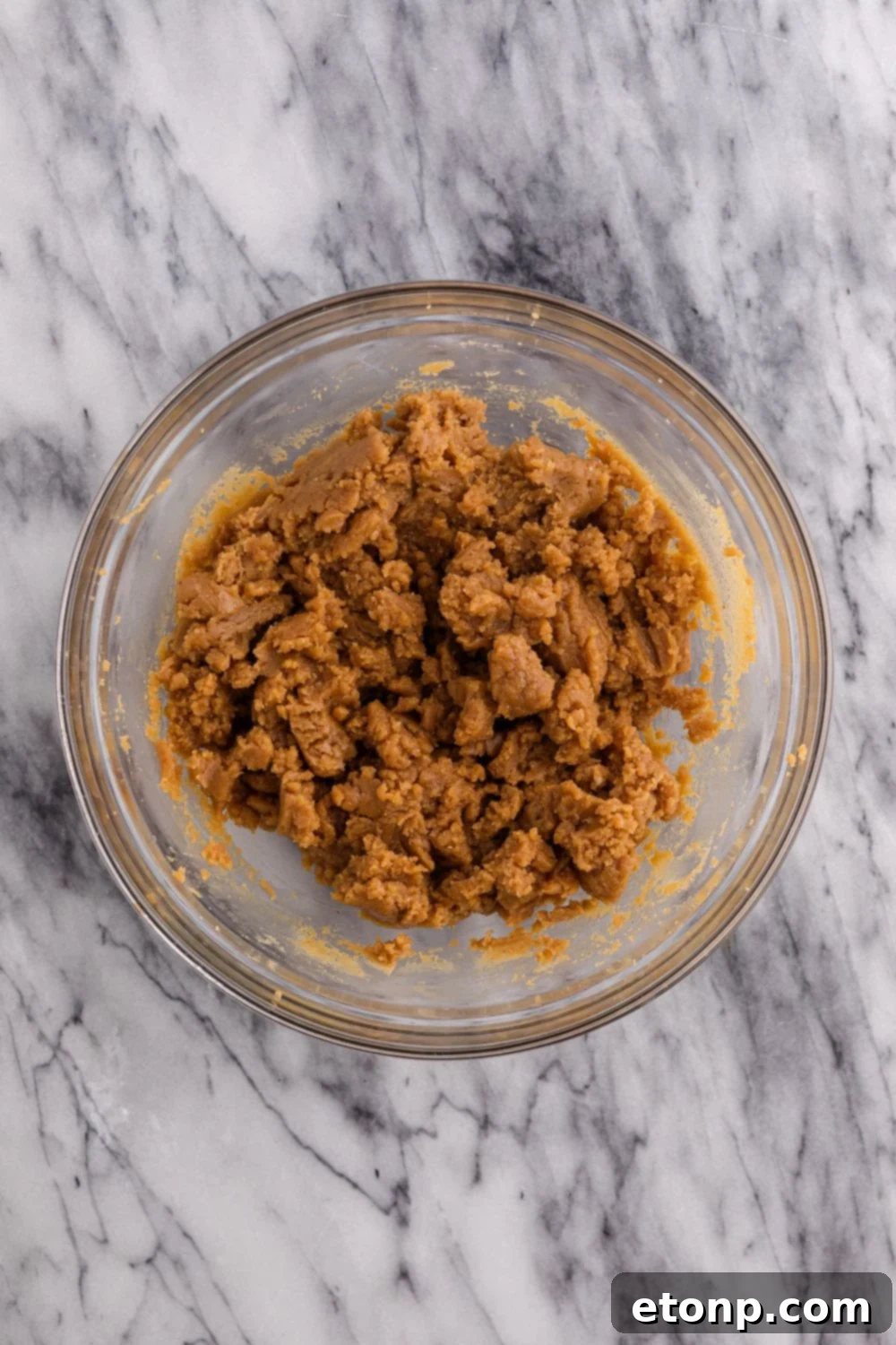 Four-Ingredient Peanut Butter Bliss: The Simplest Cookie Recipe Ever 7 A glass bowl of peanut butter mixture