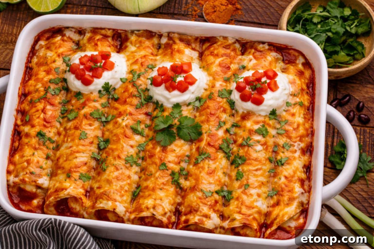 Beefy Enchiladas: A Fiesta of Flavor 23 Steak Enchiladas in a baking dish with sour cream and tomatoes