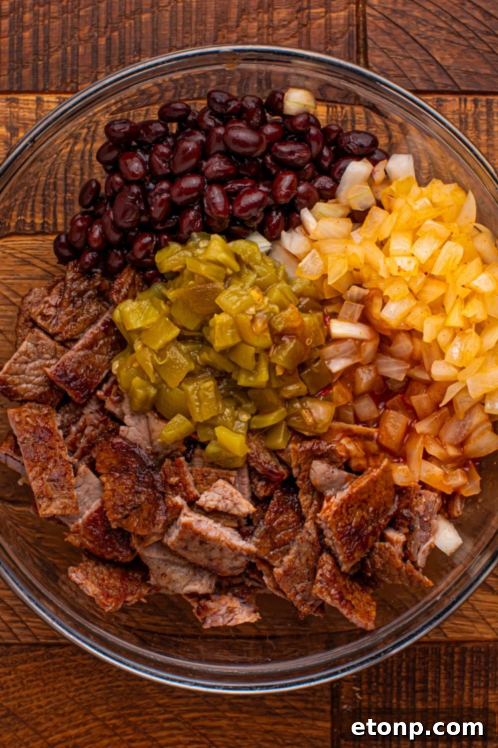 Beefy Enchiladas: A Fiesta of Flavor 6 Steak mixture in a glass bowl