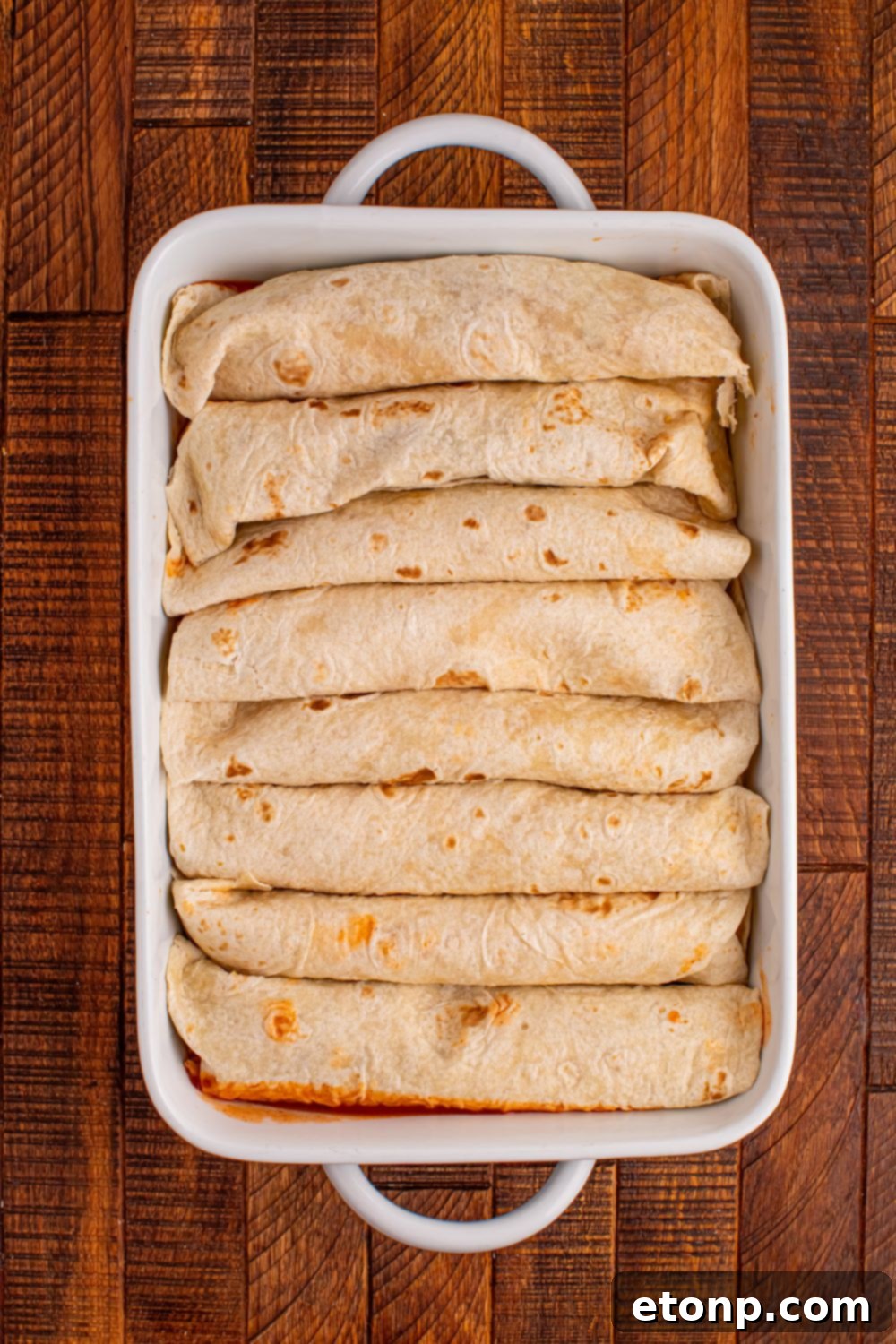 Beefy Enchiladas: A Fiesta of Flavor 8 Rolled enchiladas in a casserole dish