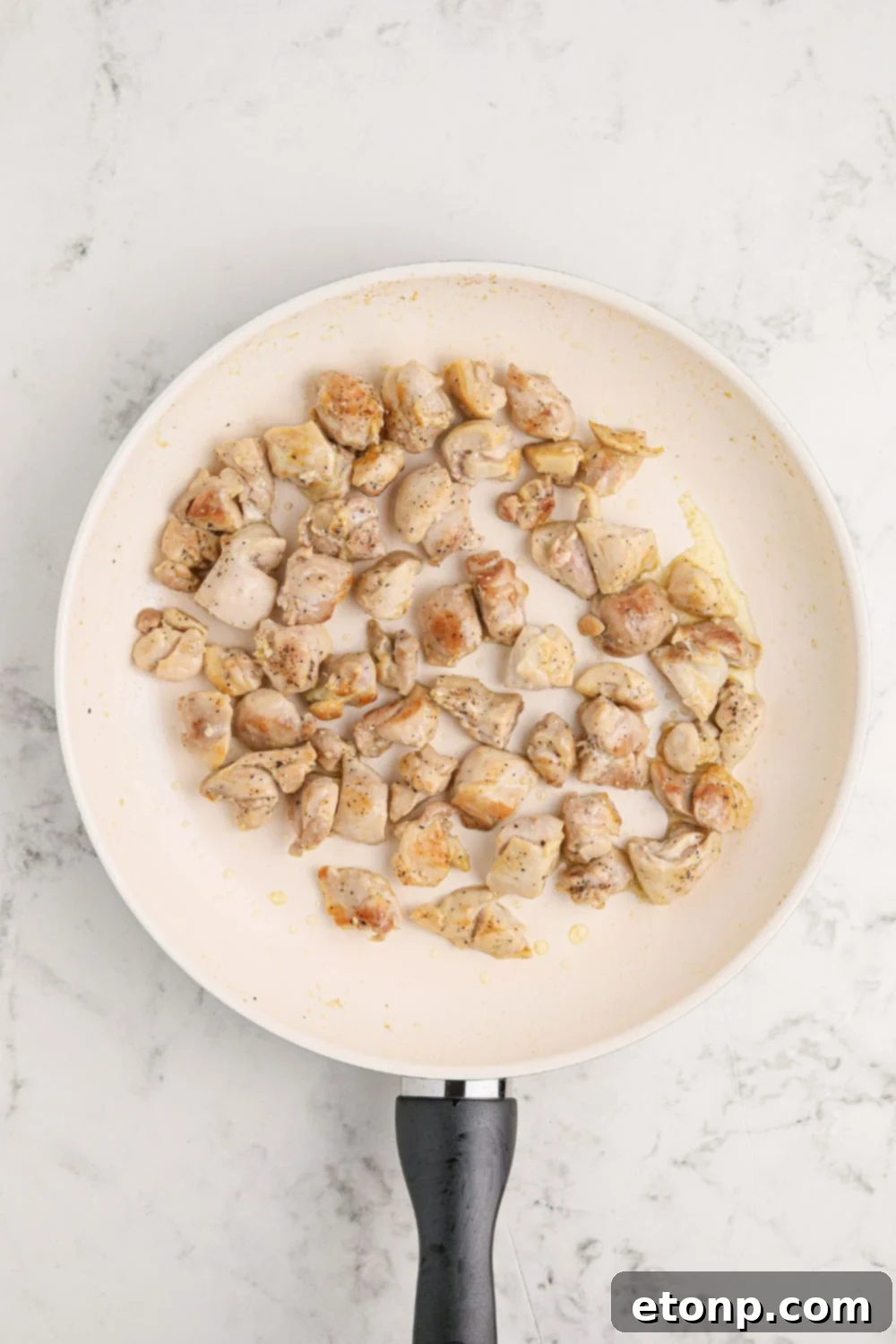 Diced chicken in a skillet