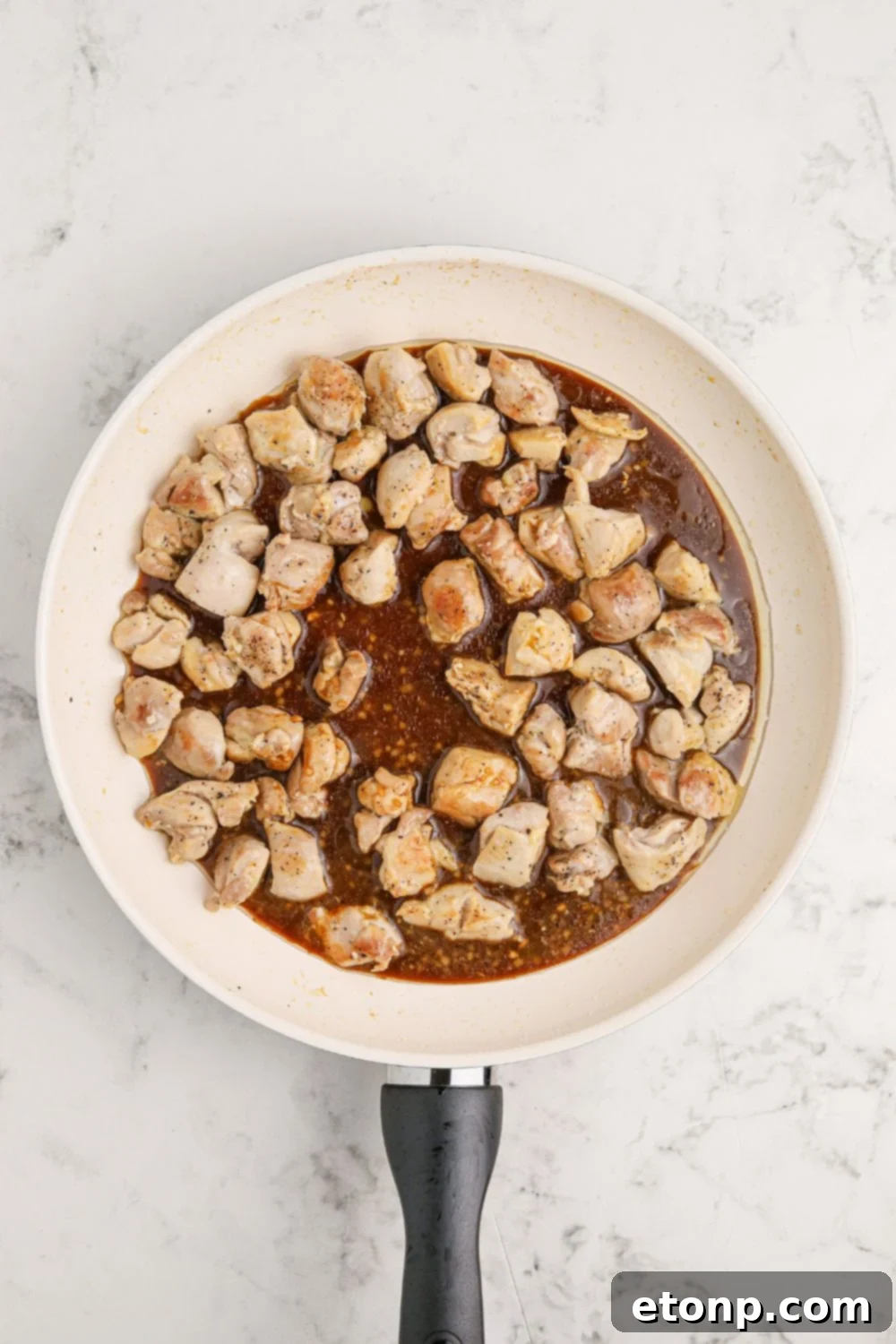 Diced chicken with sauce in a skillet
