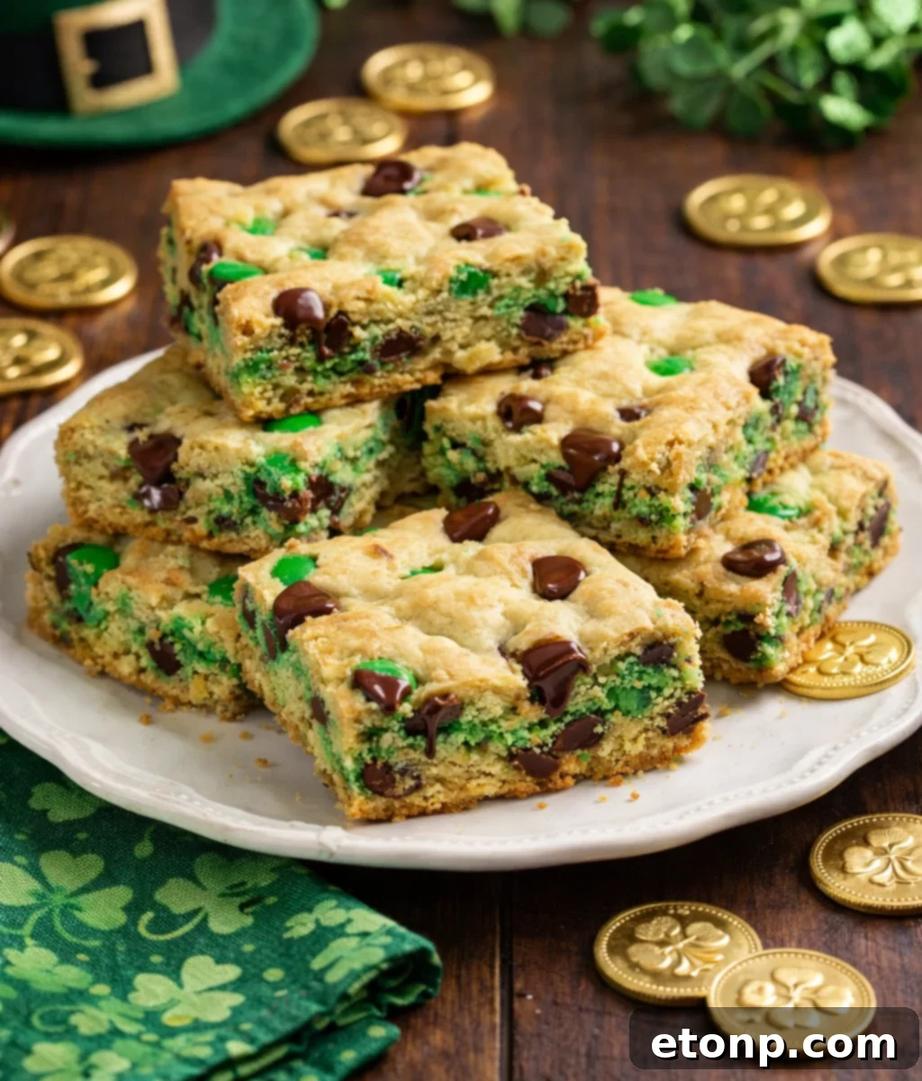 St. Patrick's Day Lucky Charm Cookie Bars 7 Saint Patrick's Day Chocolate Chip Cookie Bars on a white plate with st paddys day decor and gold coins around