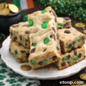 St. Patrick's Day Lucky Charm Cookie Bars 9 Saint Patrick's Day Chocolate Chip Cookie Bars on a white plate