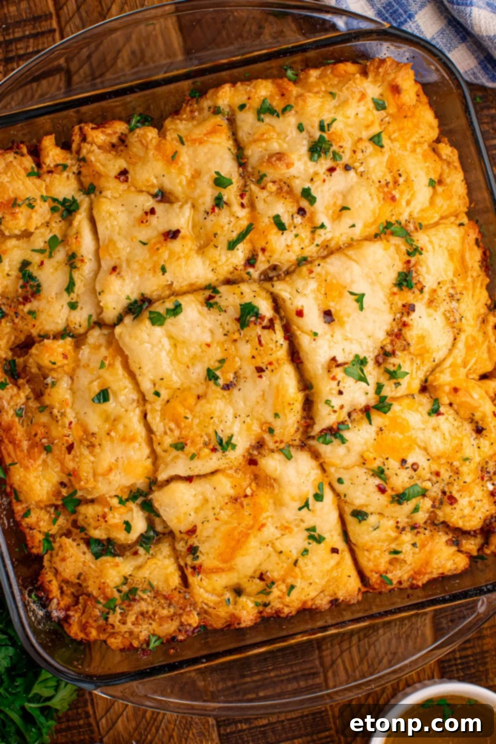 Effortless Butter Drenched Cowboy Biscuits 3 An overhead view of Cowboy Butter Swim Biscuits sliced into squares in a glass baking dish.