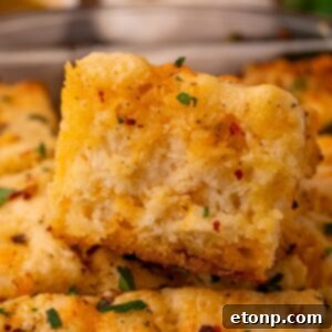 Effortless Butter Drenched Cowboy Biscuits 13 Cowboy Butter Swim Biscuits in a glass pan on table with one close up on the biscuit