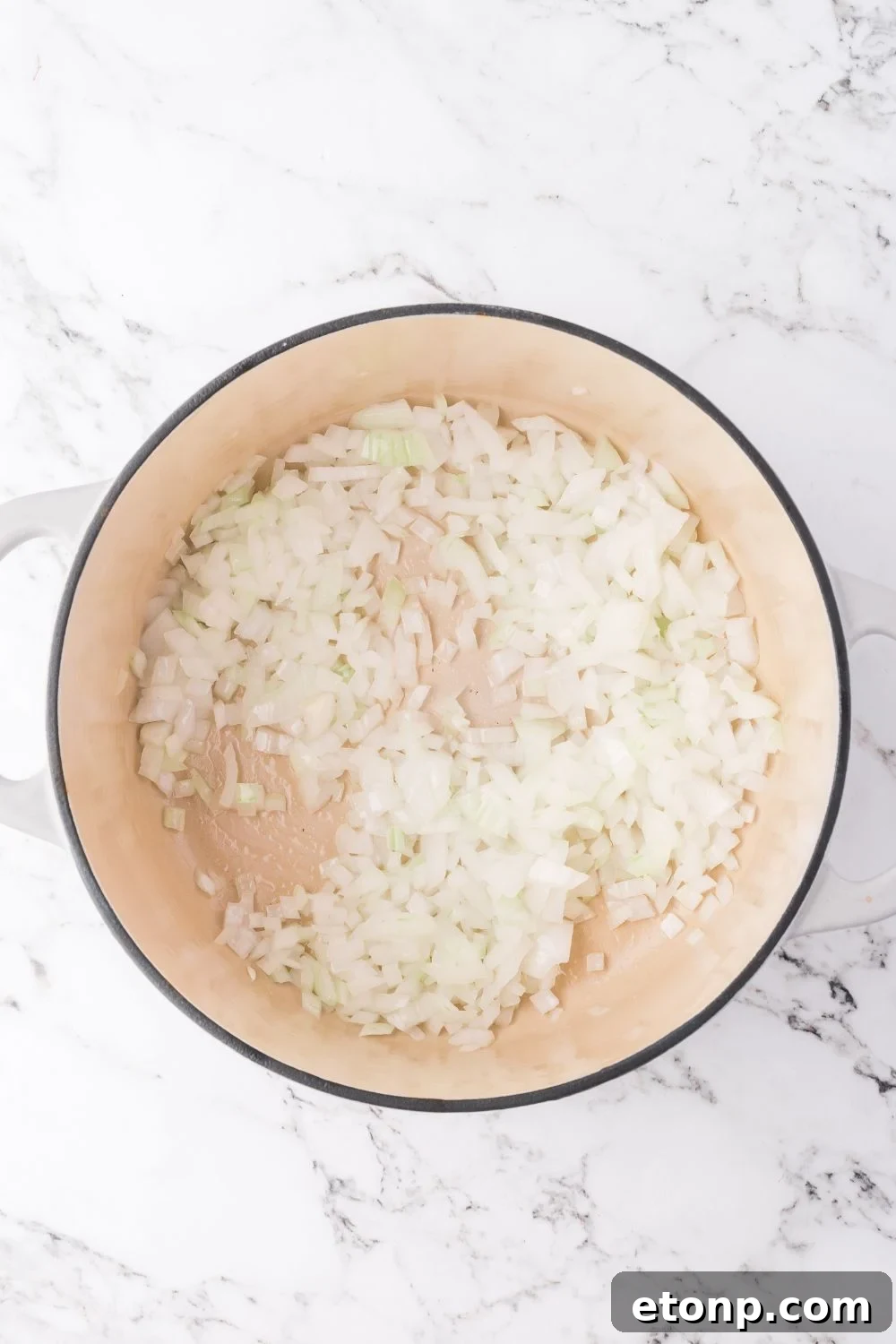 onions in a pot sitting on a marble counter for making southwest chicken soup