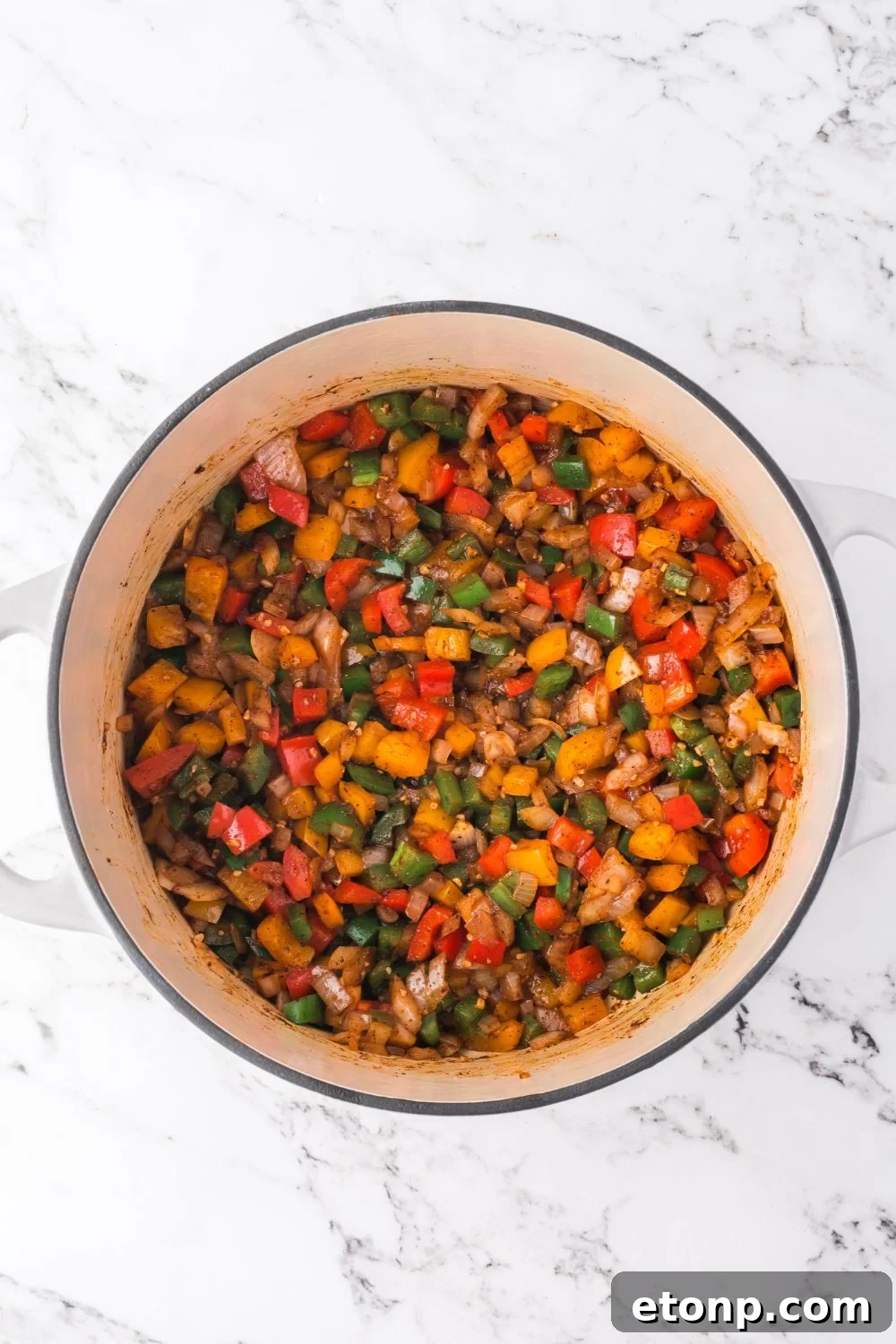 sauteed veggies  pot sitting on a marble counter for making southwestern chicken soup