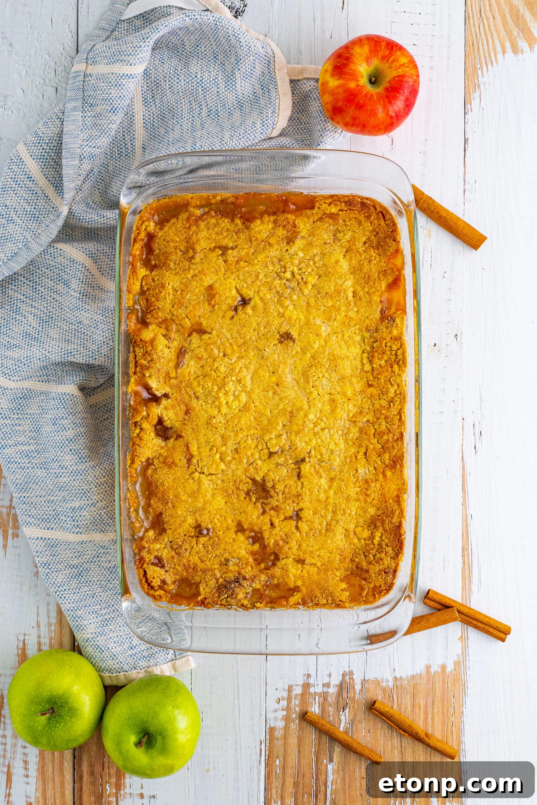 Overhead shot of the caramel apple dump cake in a clear baking dish.